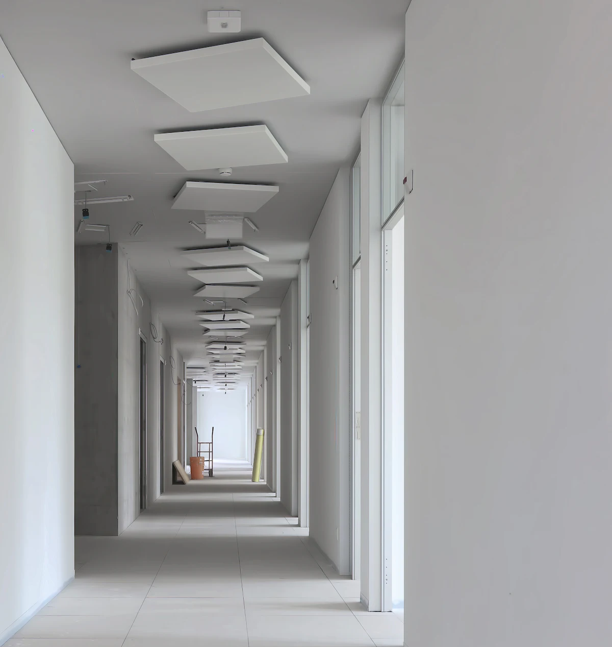 Corridor with a finished false ceiling and recessed light panels