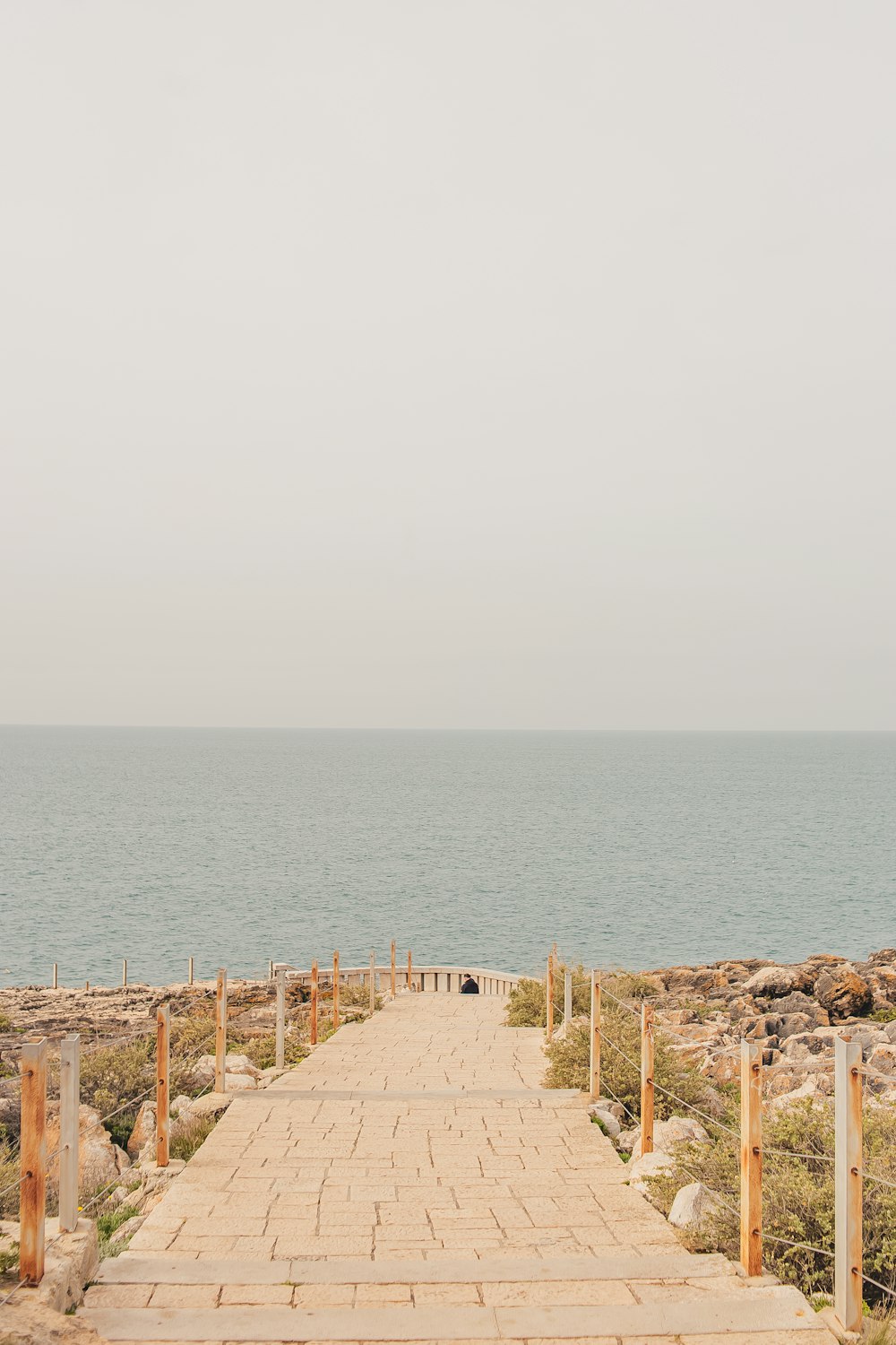 a sandy beach next to a body of water