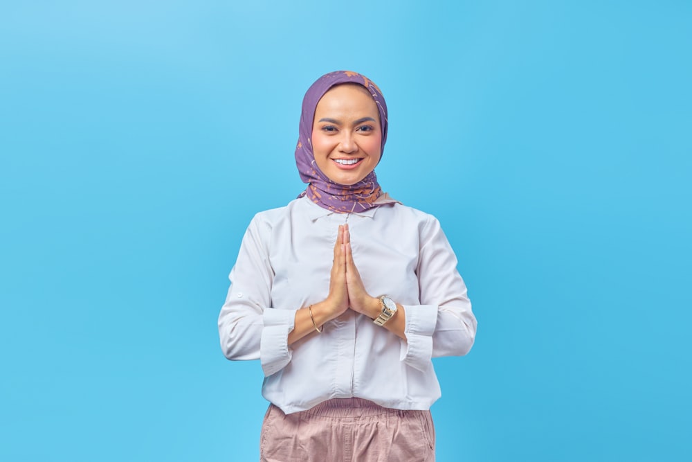 a woman wearing a headscarf and smiling