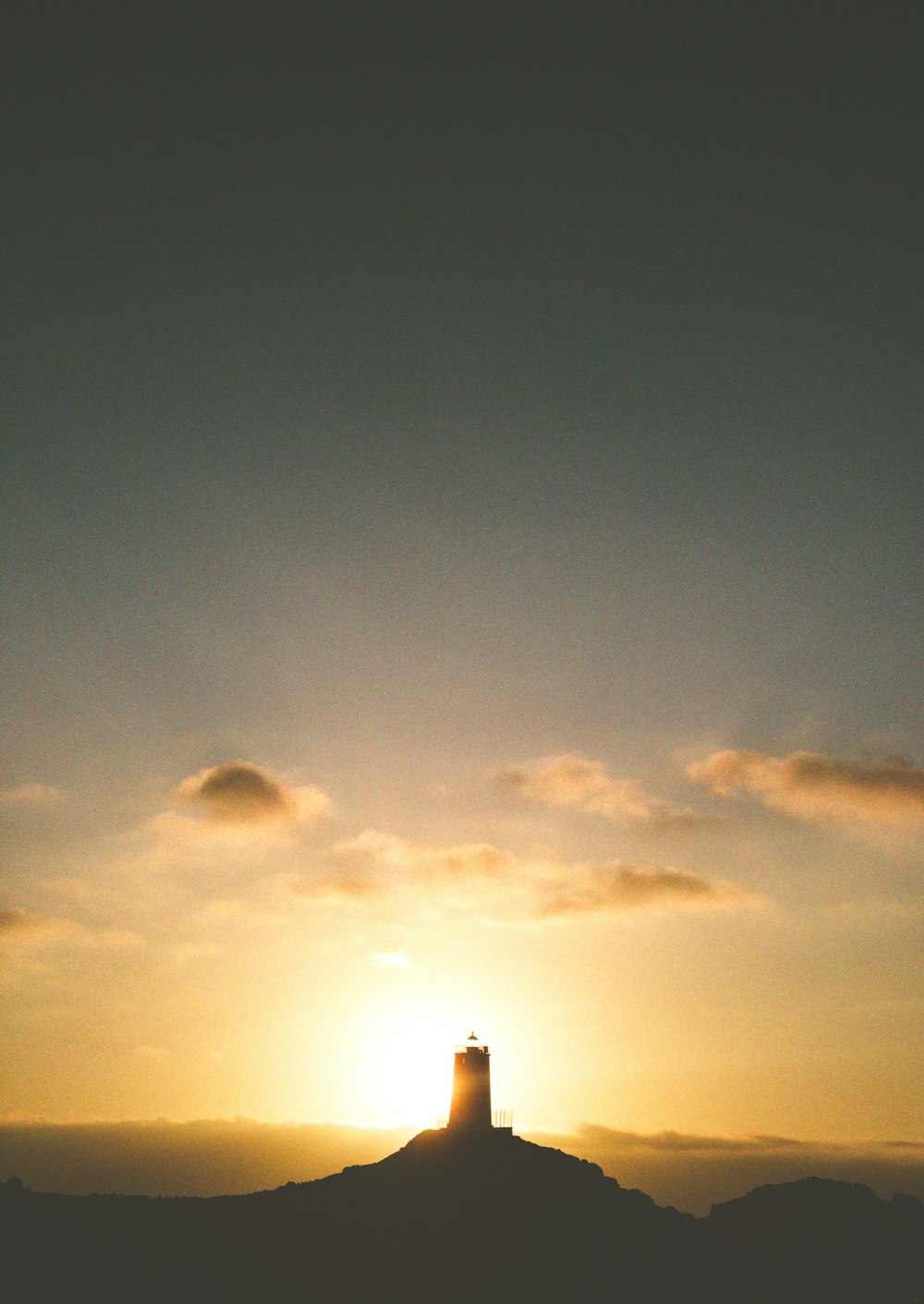 a group of clouds in the sky at sunset