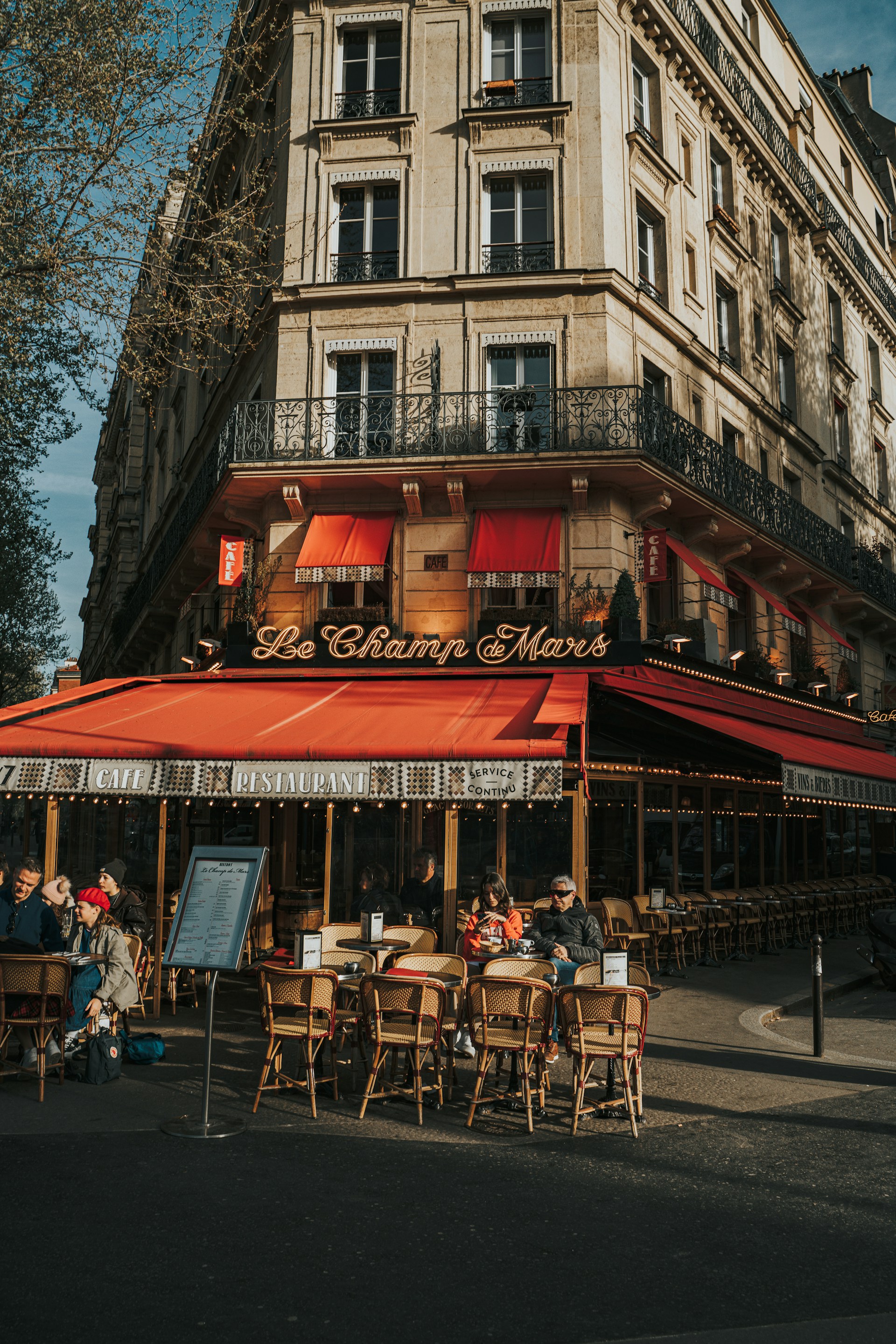 a group of people sitting outside of a restaurant