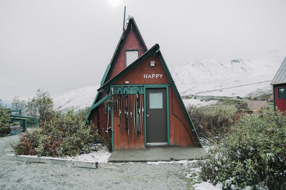 a small red building with a happy sign on it