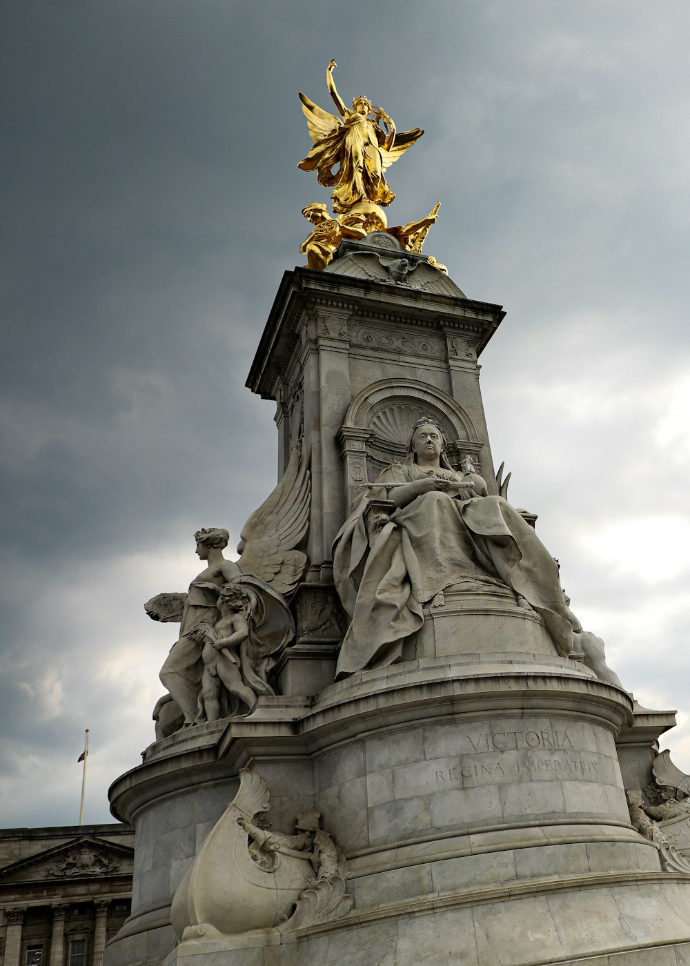 a statue with a golden angel on top of it