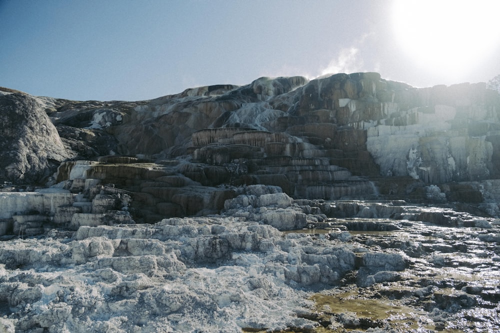 the sun shines brightly on the rocky terrain