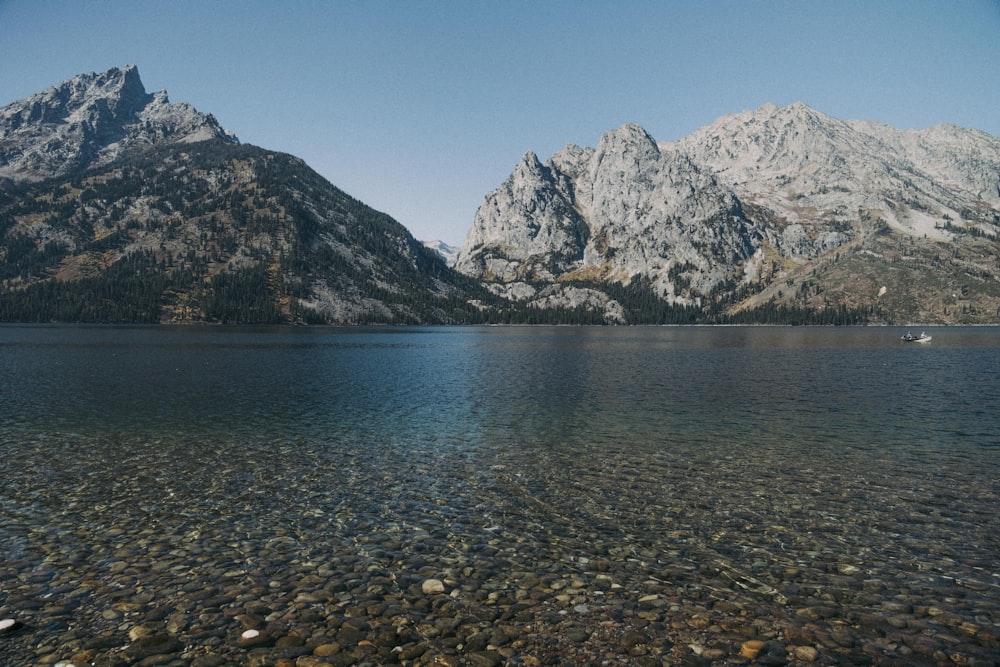 a body of water with mountains in the background