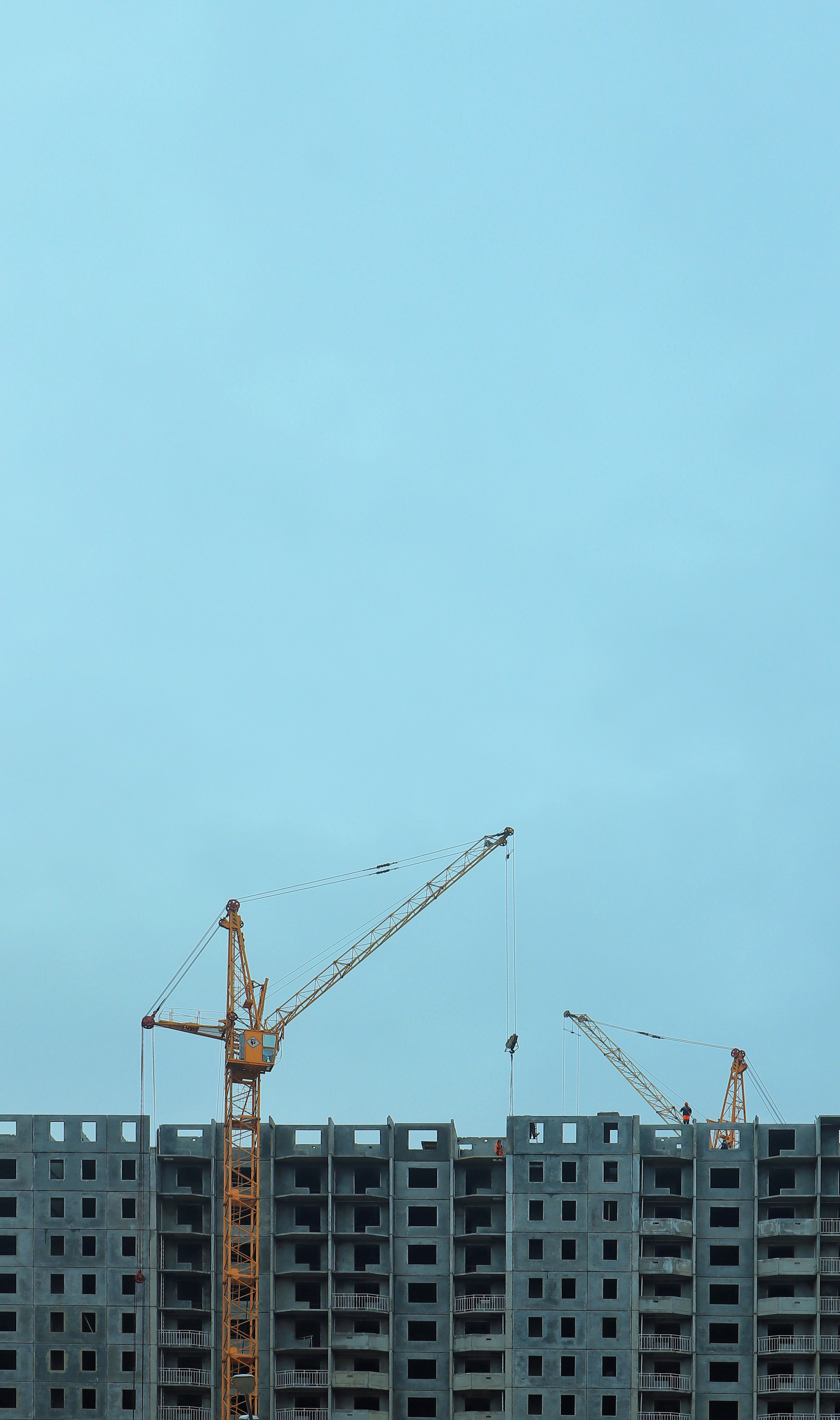 a large building under construction with cranes on top of it