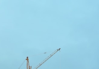 a large building under construction with cranes on top of it