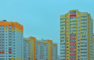 a couple of tall buildings sitting next to each other