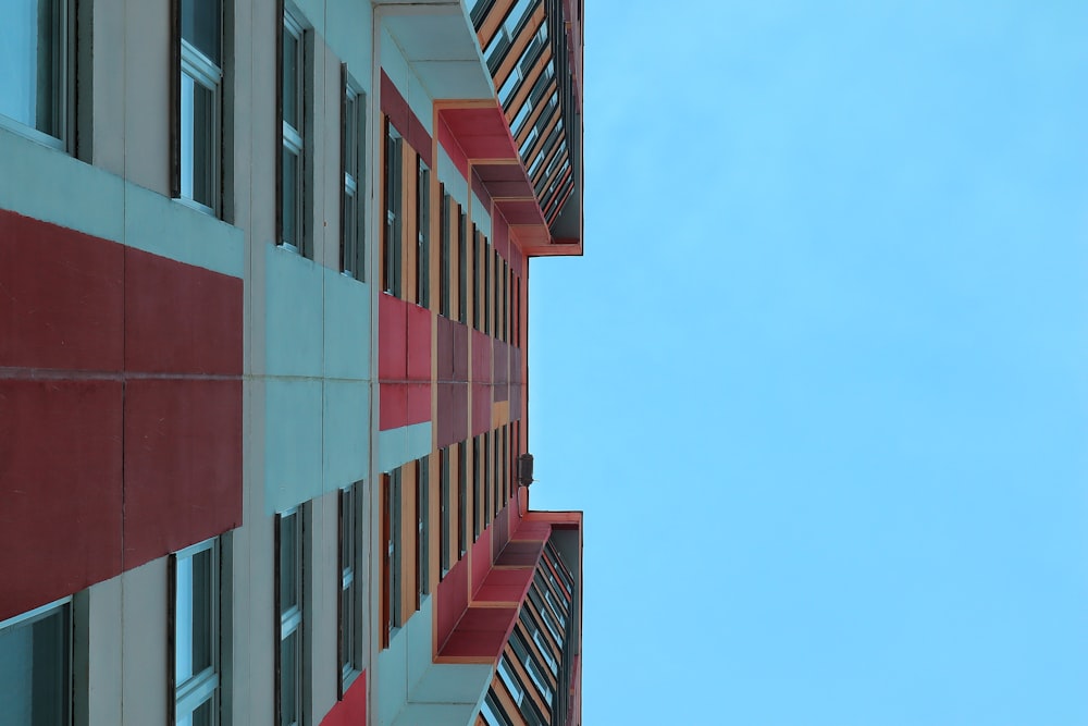 a red and white building with a blue sky in the background