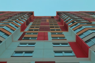 a tall multi - colored building with lots of windows