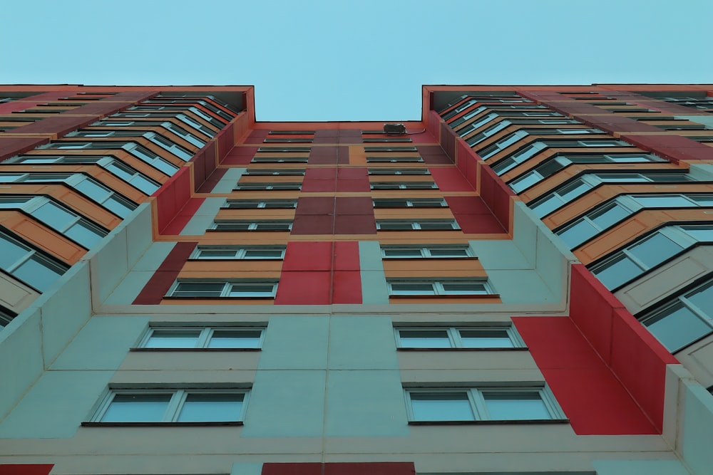 a tall multi - colored building with lots of windows