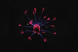 Plasma cleaning device emitting a soft blue glow over a sample tray.