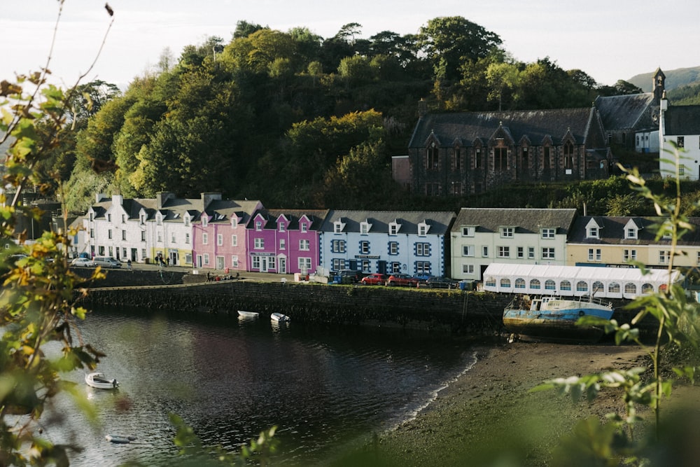 a row of houses on the shore of a river