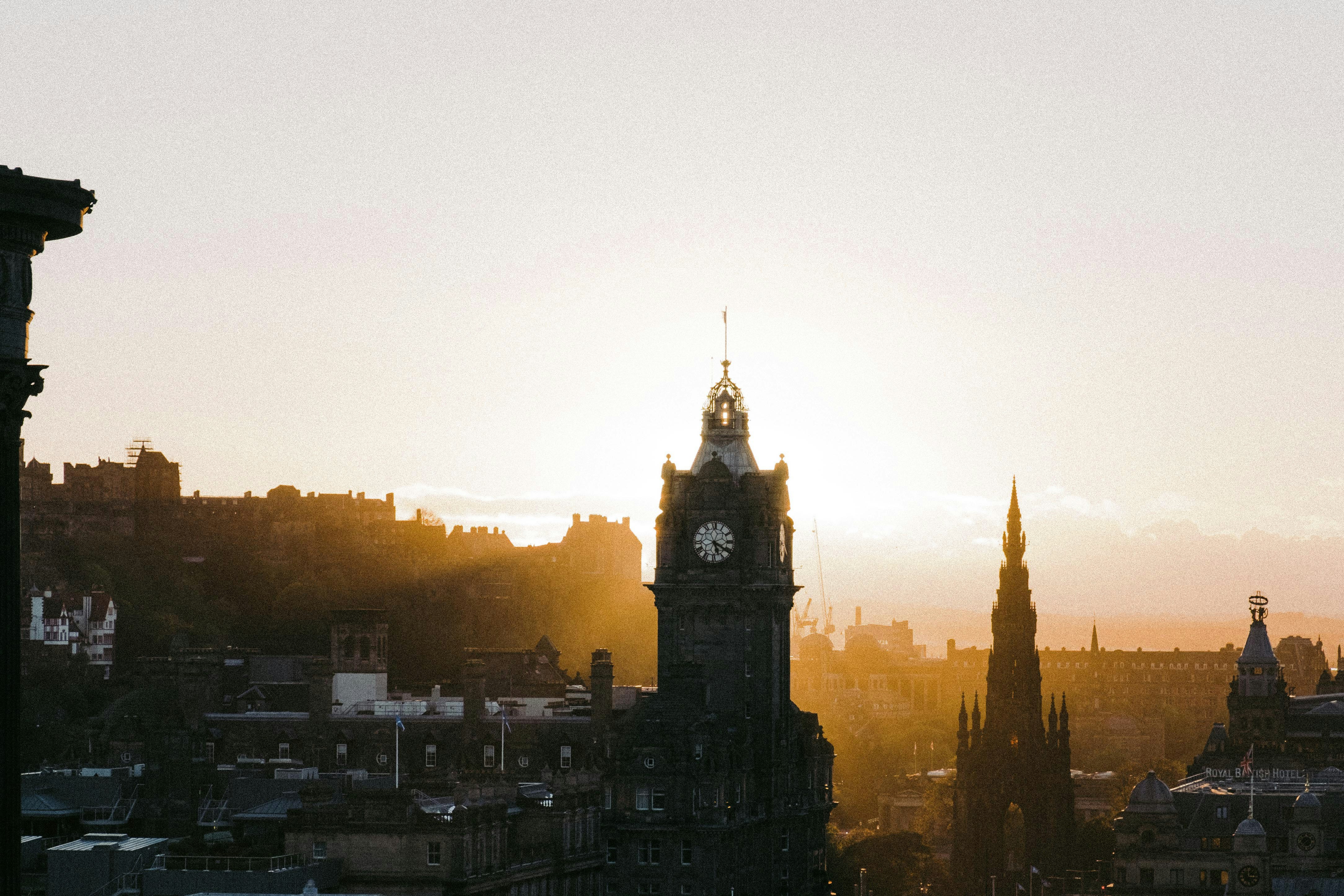 a clock tower in the middle of a city, 