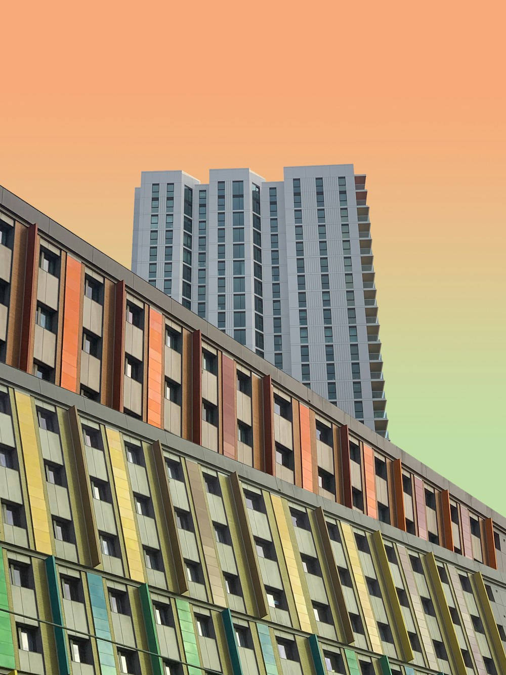 a multicolored building with tall buildings in the background