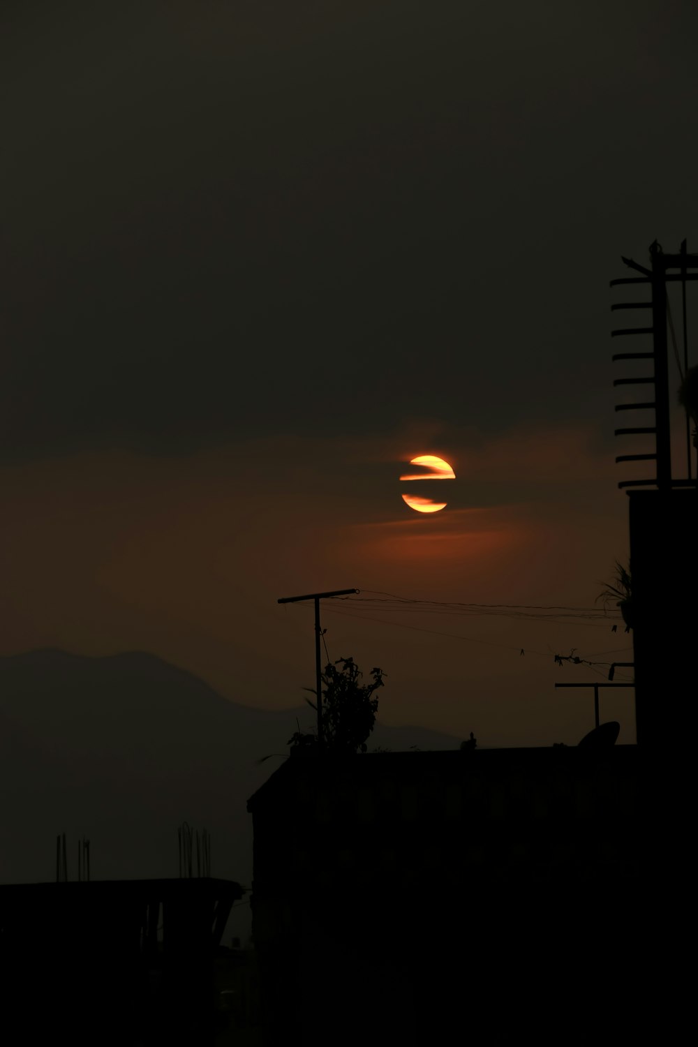 the sun is setting over a city skyline