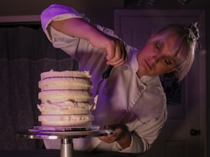 a woman cutting a cake with a knife