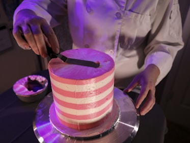 a person cutting a cake with a knife
