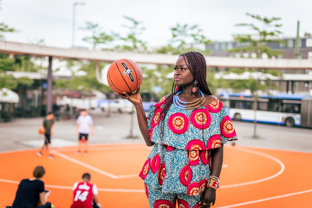 a woman holding a basketball on a basketball court