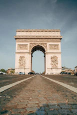 a large stone arch with a statue on top of it