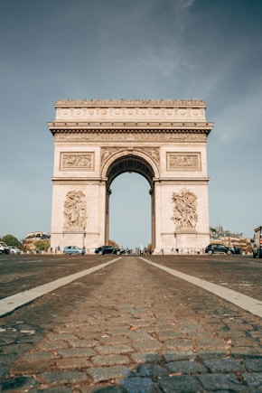 a large stone arch with a statue on top of it