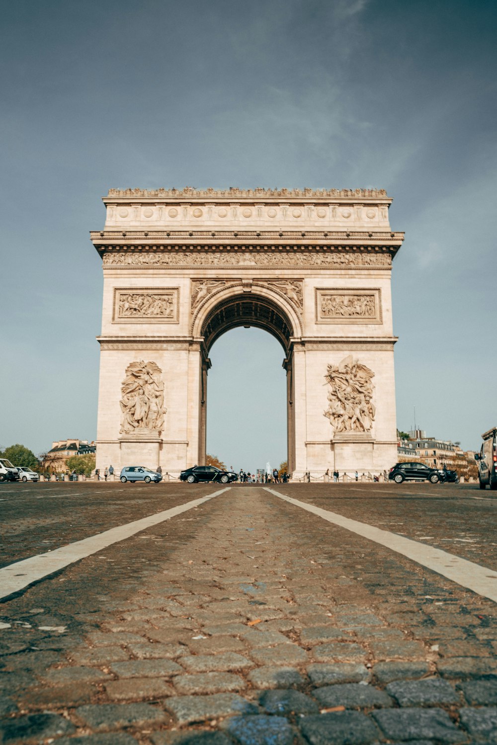 a large stone arch with a statue on top of it