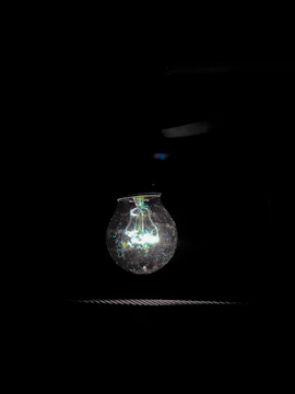 A close-up of a cracked light bulb symbolizing broken energy promises.