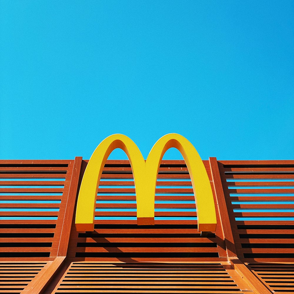 a wooden bench with a mcdonald's logo on it