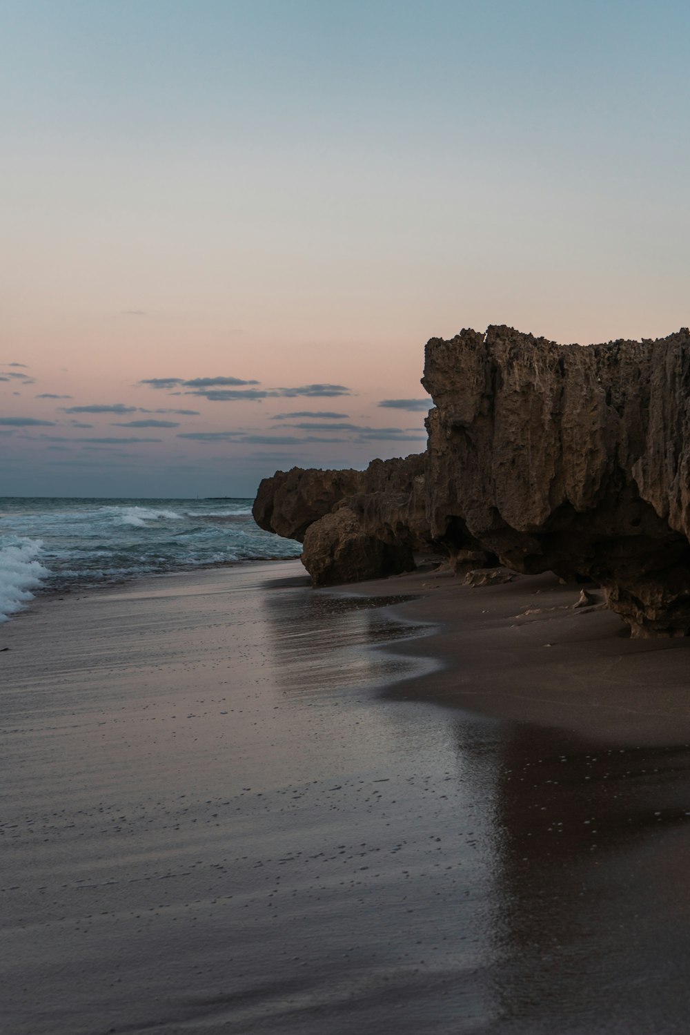 a beach with waves coming in to the shore