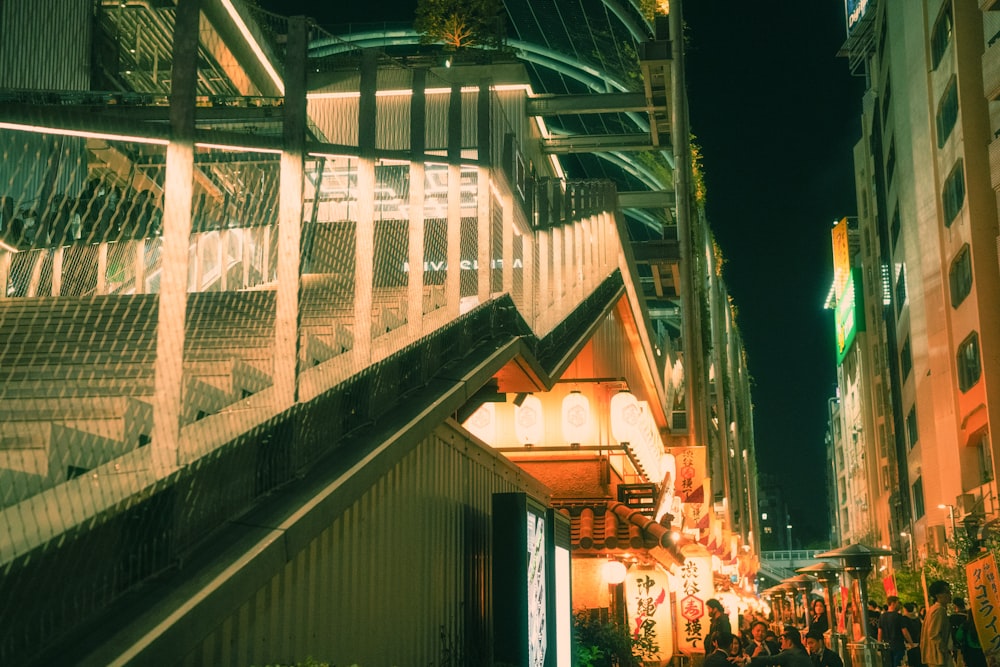 a group of people walking down a street next to tall buildings