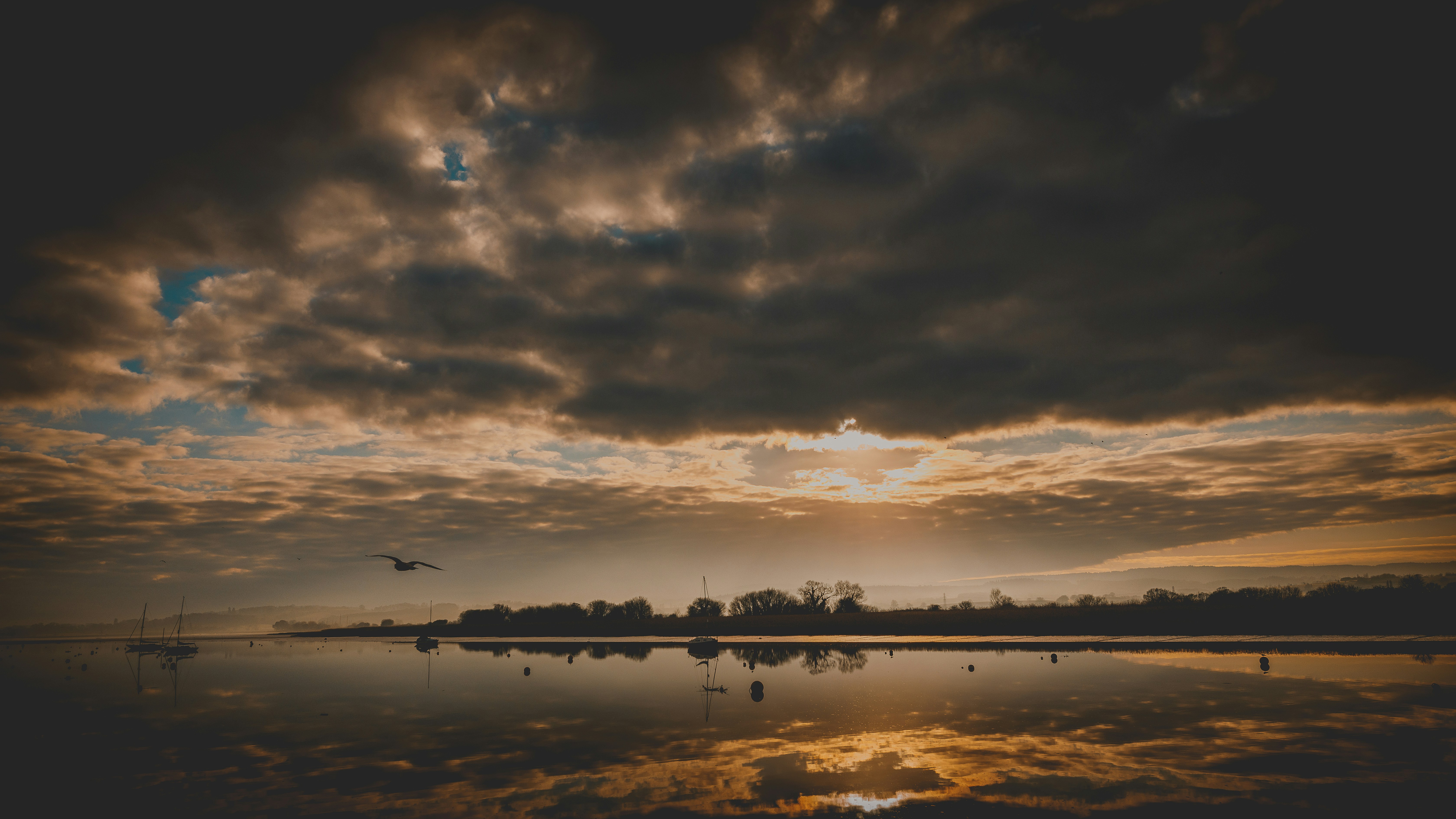the sun is setting over a body of water