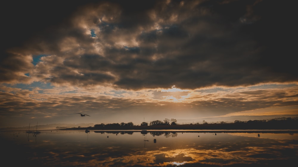 the sun is setting over a body of water