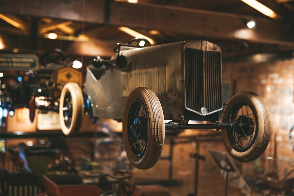 a car hanging from the ceiling in a garage