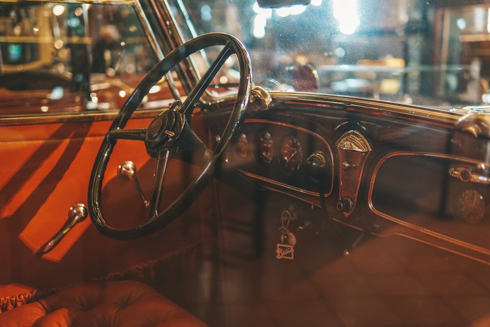 the interior of an old car with a steering wheel