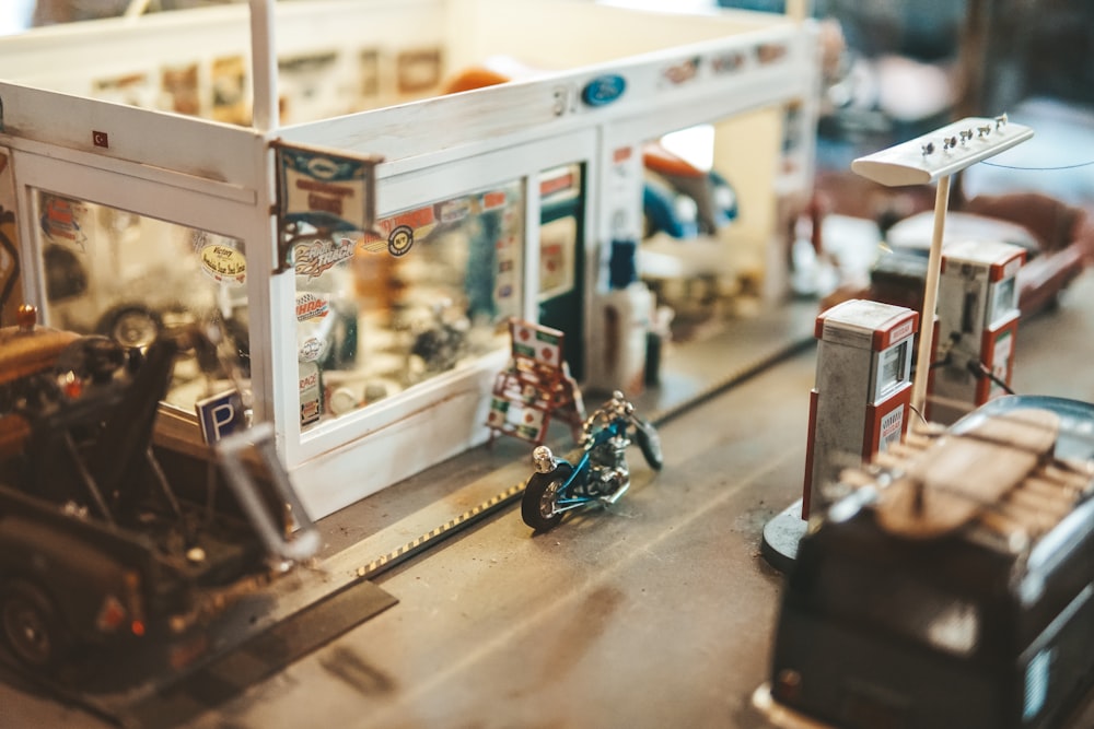 a toy model of a gas station with motorcycles and cars