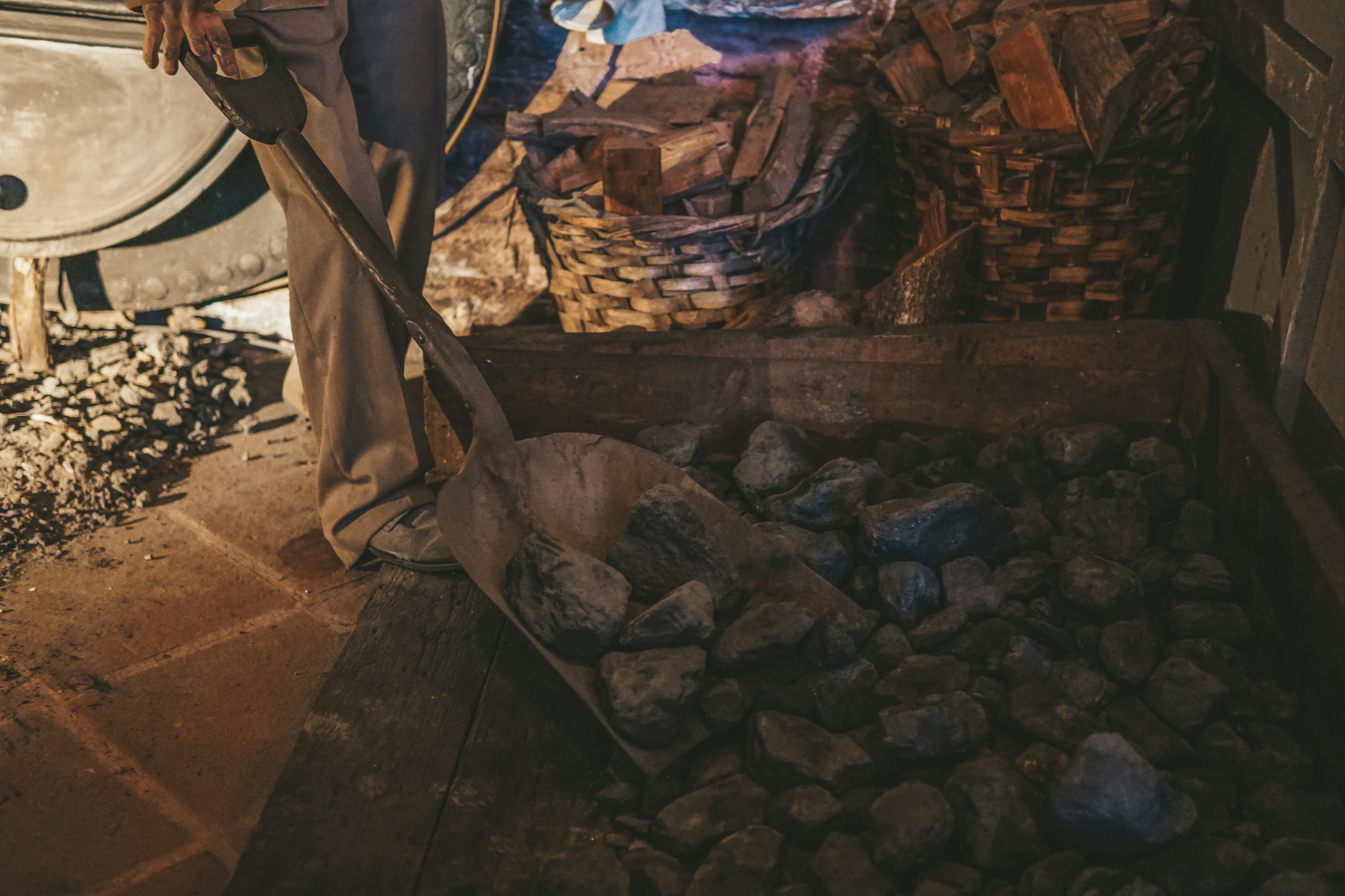 a man standing next to a pile of rocks