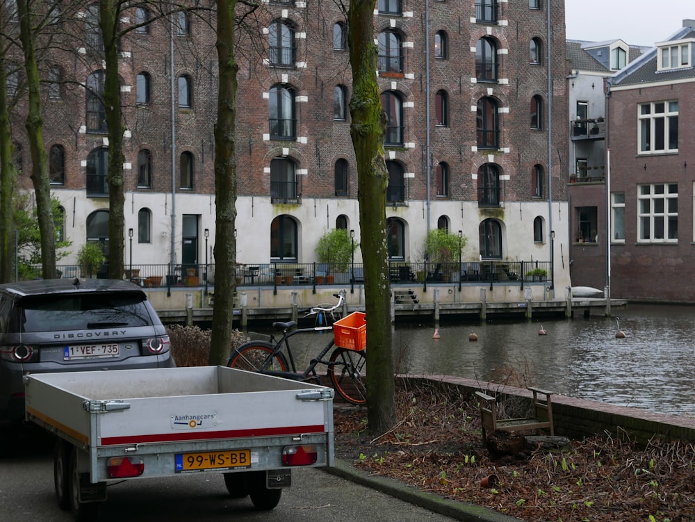 a truck parked next to a body of water