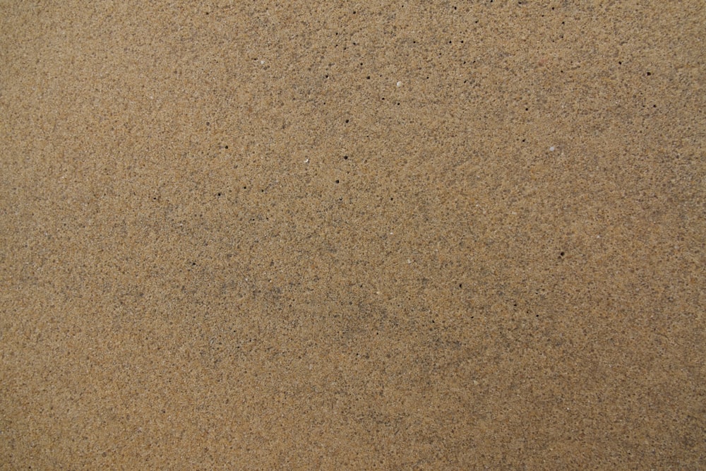 a close up of a sand surface with a small amount of sand