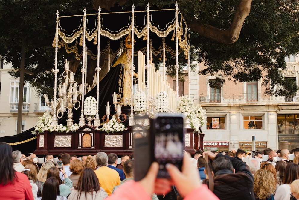 a crowd of people standing around a shrine