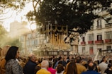 A large crowd gathered outdoors under festive decorations celebrating a spiritual feast.