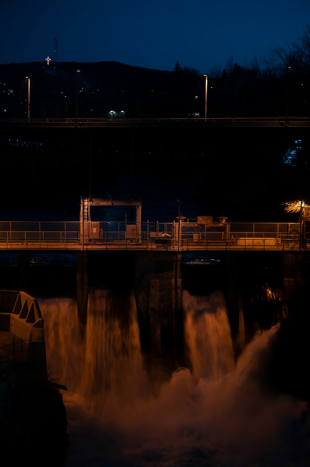 a bridge over a body of water at night