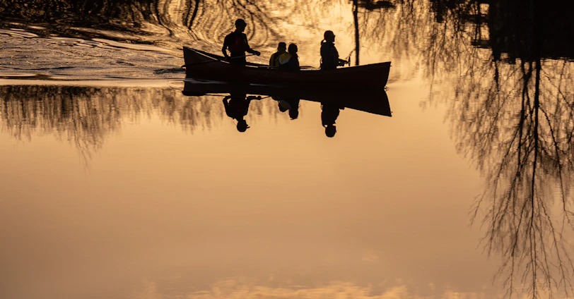 a group of people on a boat in the water