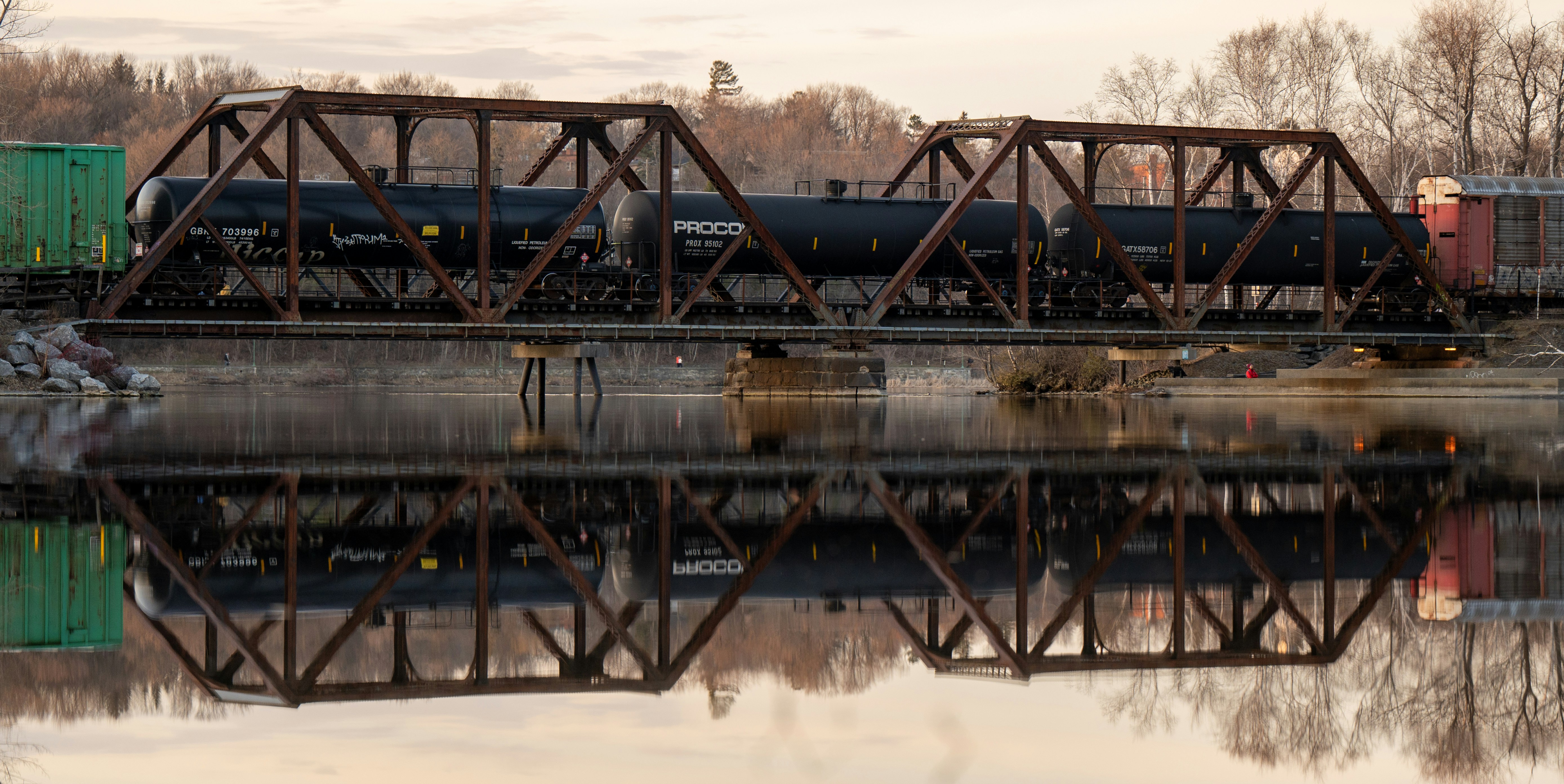 a train traveling over a bridge over a river
