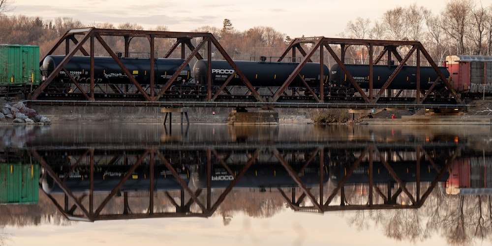 a train traveling over a bridge over a river