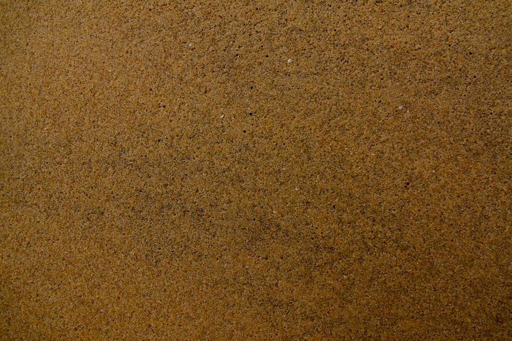 a close up of a brown sand surface