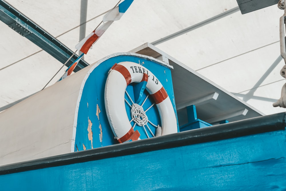 a blue boat with a life preserver attached to it