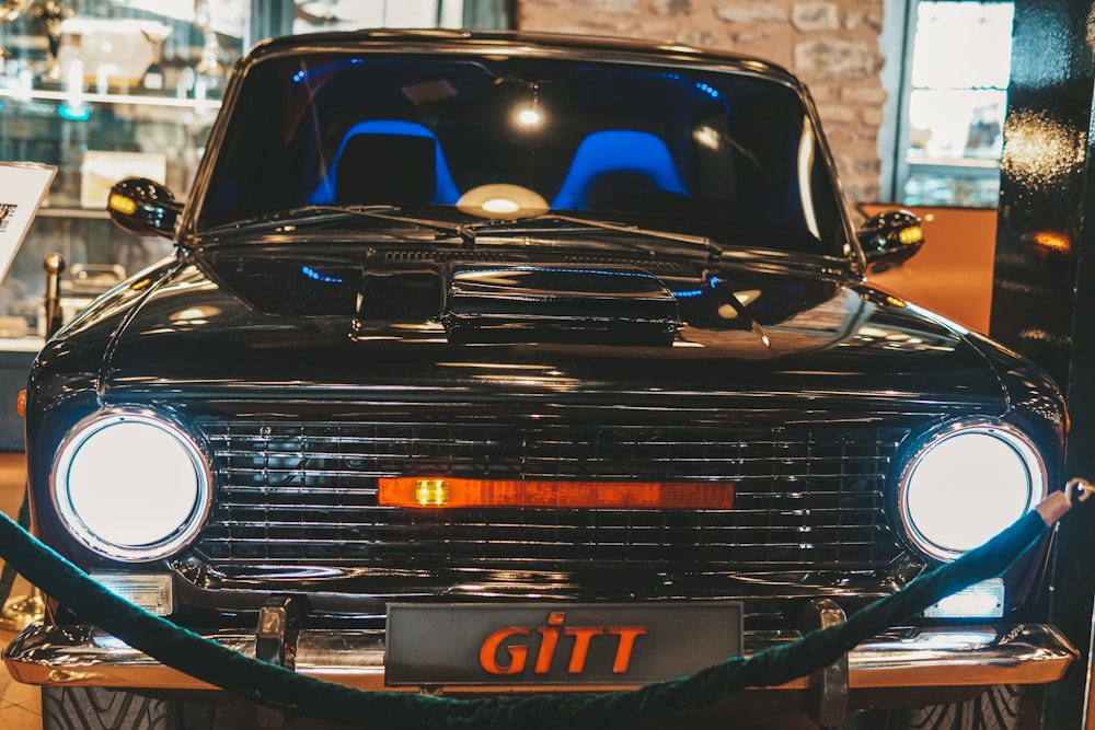 an old car is parked in a museum