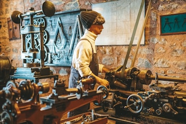 a man working on a machine in a factory