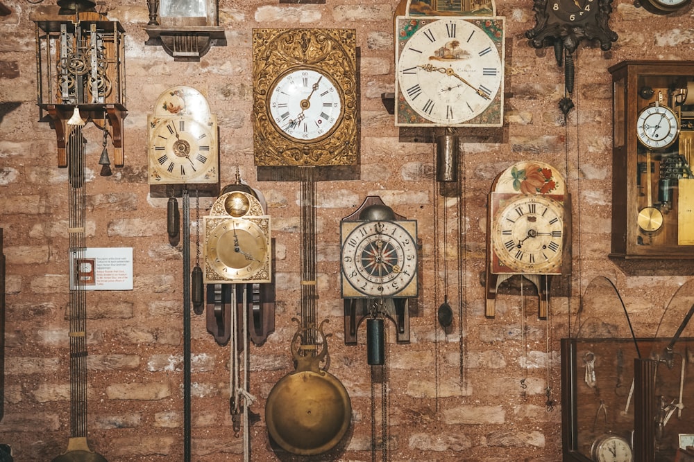 a bunch of clocks that are on a wall