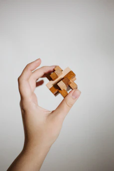 Hands crafting a complex puzzle symbolizing natural intelligence problem solving.